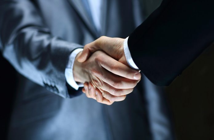 Handshake - Hand holding on black background