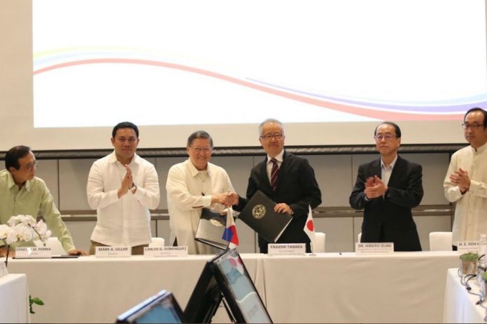 Finance Sec. Carlos Dominguez and Japan International Cooperation Agency Senior Vice President Yasushi Tanaka shake hands after signing a $202-million (P10.5 billion) loan agreement to build and improve roads in Mindanao, including war-torn Marawi City. Photo via Department of Finance